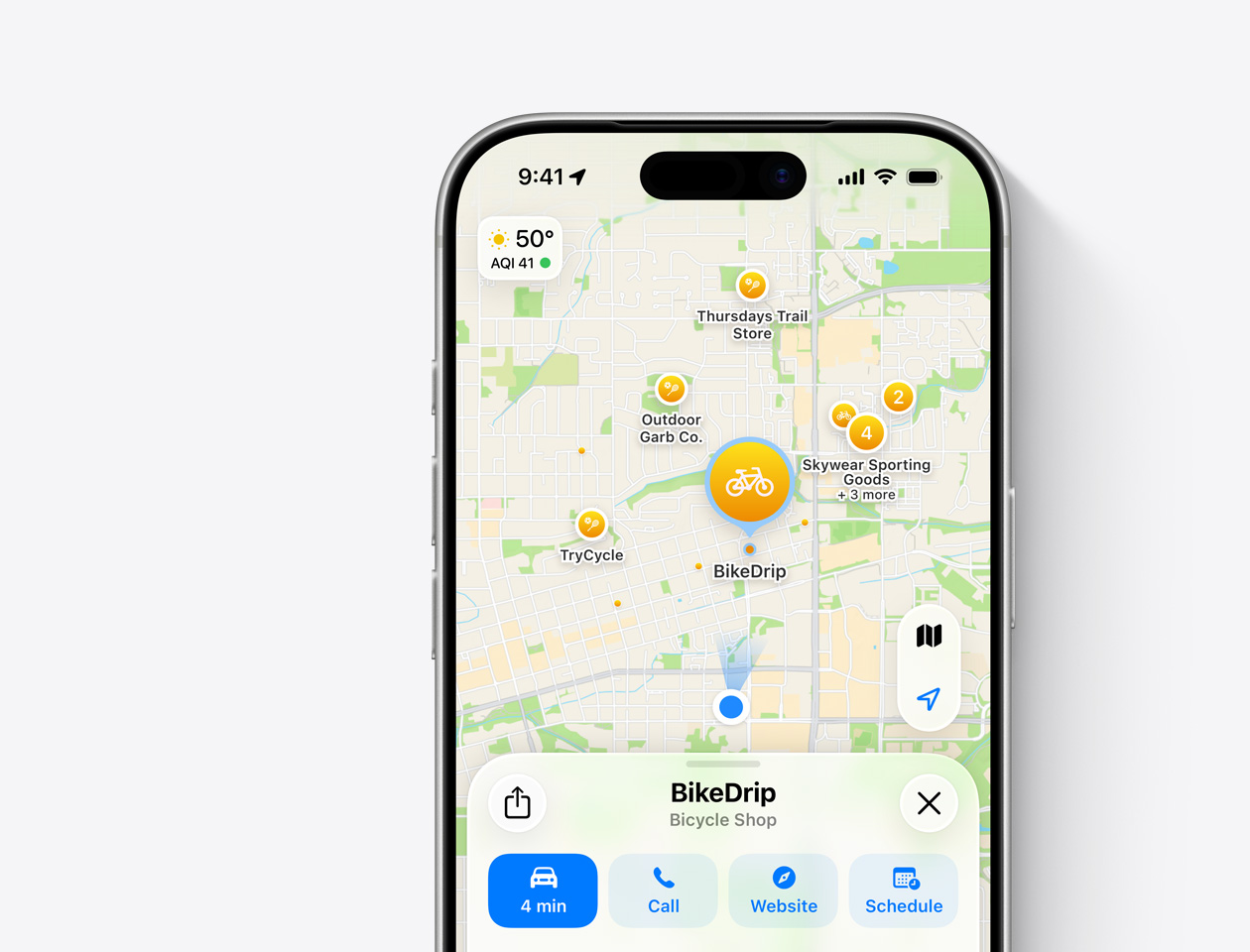 An iPhone showing Apple Maps with a promoted pin for BikeDrip, a fictional bicycle shop, displayed as the featured result with a place card at the bottom of the screen.