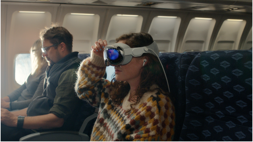 A person wearing Apple Vision Pro with AirPods Pro in their ears.